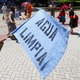 A sign at a protest in California reads, “Clean water.”